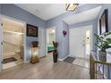 Welcoming foyer with a view of the bathroom, bedrooms, and an elegant light fixture at 14566 Quail Trail Cir, Orlando, FL 32837