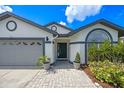 Inviting front entrance with decorative plants, a paved walkway, and a modern door at 14566 Quail Trail Cir, Orlando, FL 32837