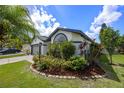 Landscaped corner lot showcasing lush greenery, a well manicured lawn, and mature trees at 14566 Quail Trail Cir, Orlando, FL 32837