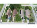 An aerial view of homes with driveways, cars and mature trees at 1612 Eastern Ave, St Cloud, FL 34771