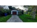 View of a home's front, showcasing a driveway, yard and single-car garage at 1612 Eastern Ave, St Cloud, FL 34771