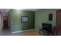 This living room shows empty green walls and an open area at 1612 Eastern Ave, St Cloud, FL 34771