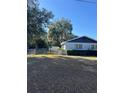 View of a fenced backyard with a small storage shed surrounded by mature trees and green shrubbery at 1732 Sw 6Th St, Ocala, FL 34471