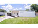 Inviting single-story home features modern exterior, well-maintained lawn, and convenient carport for parking at 1824 Dorris Dr, Orlando, FL 32807