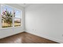 Bright bedroom featuring hardwood floors, a large window, and neutral walls at 2018 Packing District Way, Orlando, FL 32804