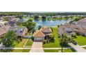 Inviting single-Gathering home boasting manicured lawn and picturesque water view at 2076 Shannon Lakes Blvd, Kissimmee, FL 34743