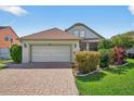 Charming single-Gathering home with a brick driveway and well-maintained landscaping at 2076 Shannon Lakes Blvd, Kissimmee, FL 34743