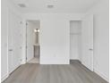 Bedroom featuring light-colored floors, closet, and bathroom access at 2290 Brix Sts, Orlando, FL 32804