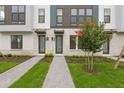 Inviting entrances with manicured lawns and paved walkways lead to modern townhomes at 2290 Brix Sts, Orlando, FL 32804