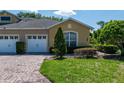 Charming townhome featuring a well-kept lawn, landscaping, brick paved driveway and two-car garage at 2673 Rutledge Ct, Winter Haven, FL 33884