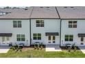Exterior rear view featuring a small patio and sliding doors for indoor/outdoor living at 3398 Vesara Dr, Davenport, FL 33837