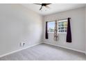 Bright bedroom with neutral walls, ceiling fan and carpet and a large window for natural light at 3515 Leslie Dr, Orlando, FL 32806