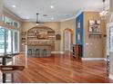 Spacious living room with hardwood floors, a custom bar area, and an open layout perfect for entertaining guests at 3619 King George Dr, Orlando, FL 32835
