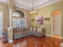 Comfortable living room featuring hardwood floors, a large window, and a neutral color scheme with decorative accents at 3619 King George Dr, Orlando, FL 32835