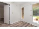 Welcoming entryway with wood-look flooring and a storm door with sidelight at 435 Boxwood Cir, Winter Springs, FL 32708