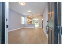Bright, open-concept living area with wood-look floors, modern lighting, and an open flow to the kitchen at 4409 W Gore Ave, Orlando, FL 32811