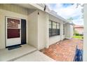 Home entrance with a brick-paved patio, covered entry, and view of side of home at 452 Sundown Trl, Casselberry, FL 32707