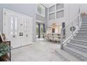 Grand foyer featuring soaring ceilings, staircase, and elegant decor at 621 Estates Pl, Longwood, FL 32779
