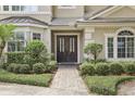 Inviting front entrance showcasing a beautiful double door and manicured landscaping at 621 Estates Pl, Longwood, FL 32779