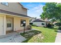 Charming home featuring a well-kept lawn, an exterior light and neutral paint tones at 628 Olympic Dr # 8-C, Ocoee, FL 34761