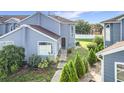 Charming townhome featuring a blue exterior, well-maintained landscaping, and a welcoming walkway at 709 Orchid Dr, Davenport, FL 33897
