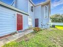 Charming townhome featuring a blue exterior, well-maintained landscaping, and a welcoming walkway at 709 Orchid Dr, Davenport, FL 33897