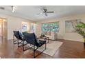Bright living room featuring hardwood floors, neutral-toned furniture, and a ceiling fan at 73 Alano Rd, Debary, FL 32713