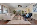 Inviting living room with hardwood floors, plush rug, and comfortable seating area with plenty of natural light at 73 Alano Rd, Debary, FL 32713