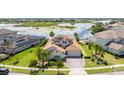 Aerial view of a beautiful home with a tile roof and waterfront views at 7388 John Hancock Dr, Winter Garden, FL 34787