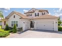 Beautiful home featuring a three car garage, tile roof and brick paved driveway at 7388 John Hancock Dr, Winter Garden, FL 34787