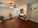 Inviting living room featuring hardwood floors, elegant furnishings, and a ceiling fan at 7709 Ravenna Ave, Orlando, FL 32819