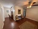 Inviting living room featuring hardwood floors, elegant furnishings and view to kitchen at 7709 Ravenna Ave, Orlando, FL 32819