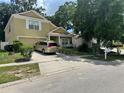 Traditional two-story home with attached garage, cozy porch, and well-maintained front yard at 7939 Riffle Ln, Orlando, FL 32818