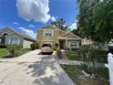 Inviting two-story home featuring manicured landscaping, an attached garage, and covered porch at 7939 Riffle Ln, Orlando, FL 32818