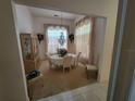 Formal dining room featuring elegant chandelier and window treatments at 8603 Snowfire Dr, Orlando, FL 32818