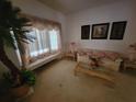 Inviting living room with large window and decorative accents at 8603 Snowfire Dr, Orlando, FL 32818
