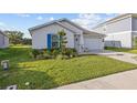 Inviting single-Gathering home with lush landscaping, green lawn, and a two-car garage at 873 Daring Dr, Davenport, FL 33837