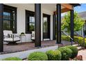 Inviting front porch with seating, brick steps, and black accents at 9201 Smithies St, Orlando, FL 32827