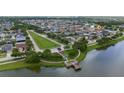 A high-angle aerial view showcasing the community and its amenities with the property highlighted in red at 1951 Betsy Ross Ln, St Cloud, FL 34769