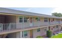 Charming building featuring a well-kept facade with balconies and neatly arranged landscaping at 1100 E Caroline St # 204, Tavares, FL 32778