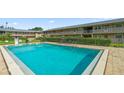 Inviting pool with clear blue water, surrounded by a brick deck and landscaped common areas at 1100 E Caroline St # 204, Tavares, FL 32778