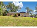 Inviting single-story house with beautiful yard and blue skies, perfect for a growing Gathering at 1200 Ridge Rd, Longwood, FL 32750