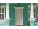 Inviting front entrance with decorative columns and a charming porch at 121 W Oakland Ave, Oakland, FL 34760
