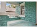 Cozy front porch with a classic swing, perfect for relaxing at 121 W Oakland Ave, Oakland, FL 34760