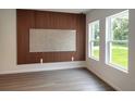 Stylish room featuring wood slat accent wall, neutral paint, and bright window light at 1309 Hillsborough Ln, Kissimmee, FL 34759