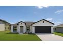 Charming single-story home boasts manicured lawn, modern design, and inviting curb appeal at 1309 Hillsborough Ln, Kissimmee, FL 34759