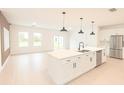 Bright, open-concept kitchen featuring a central island with stainless steel appliances at 1309 Hillsborough Ln, Kissimmee, FL 34759