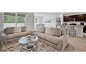 Comfortable living area featuring plush seating, round glass table, and open flow to the dining at 1351 Fox Squirrel Dr, Davenport, FL 33897