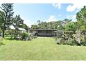 Expansive backyard showcasing lush greenery and potential for outdoor living at 1390 E Airport Blvd, Sanford, FL 32773