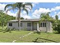 Well-kept single-story home with a spacious front yard and inviting entryway at 1390 E Airport Blvd, Sanford, FL 32773